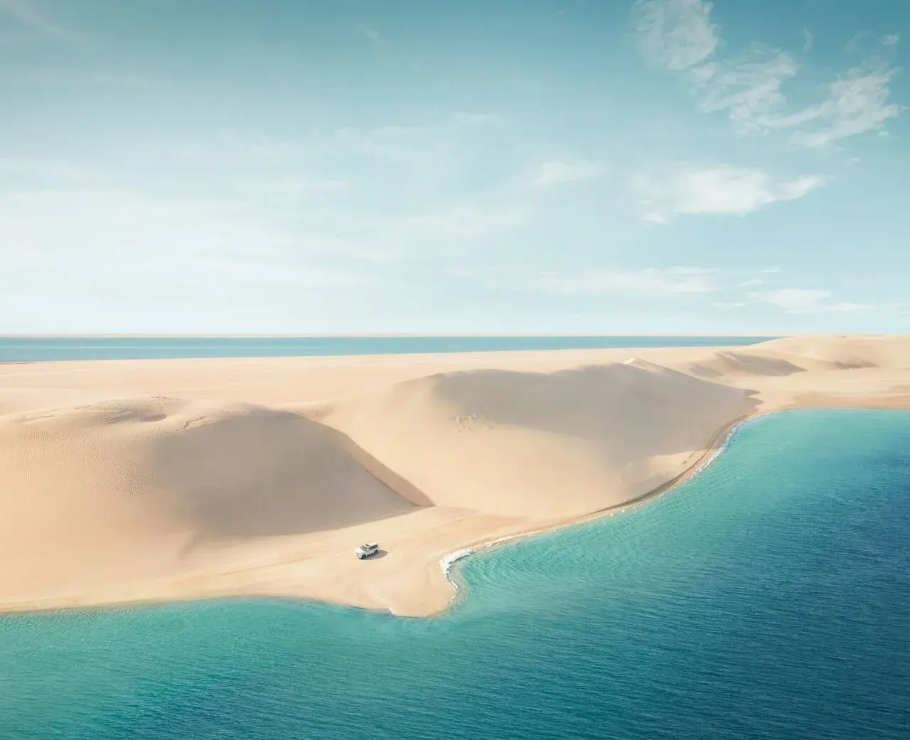 Sand dunes meeting the Inland Sea at Khor Al Adaid, Qatar